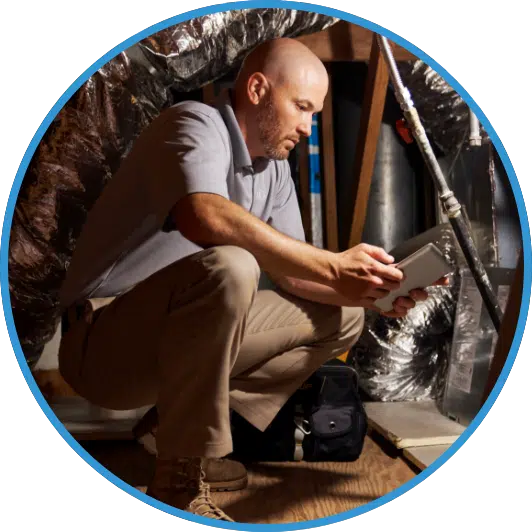 A HVAC technician looks over a checklist before working on a furnace.