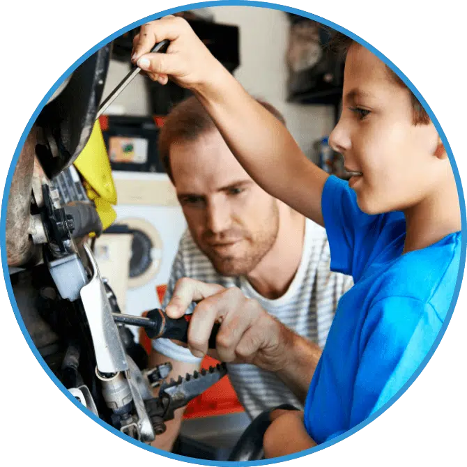 A child an adult work in the garage