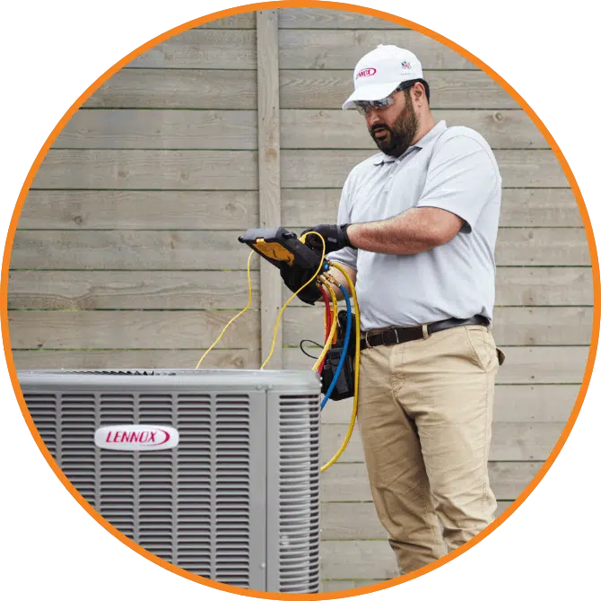 A HVAC technician checks an air conditioner